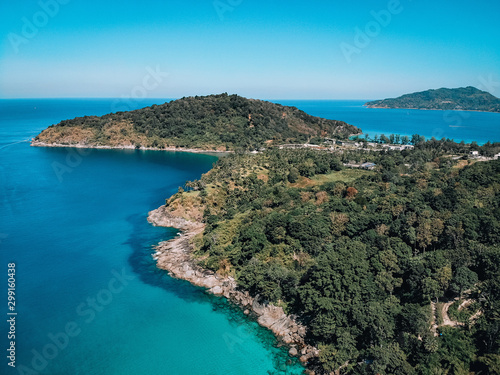 Drone view of the lagoon: narrow strip of the white sand, clear blue water and green hills covered with tropical forest  paradise concept. © Semachkovsky 