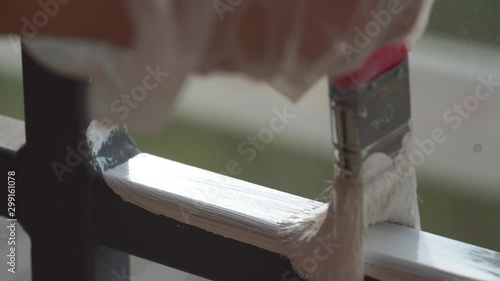 Painting metal structures with white paint using a brush