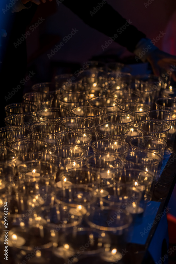 Tea light candles in plastic cups for night celebration event