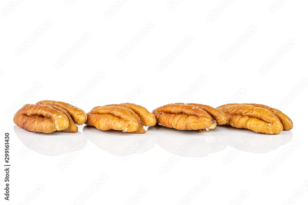 Group of four whole dry brown pecan nut isolated on white background