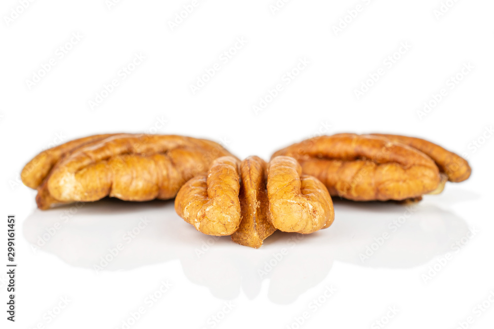 Group of three whole dry brown pecan nut isolated on white background