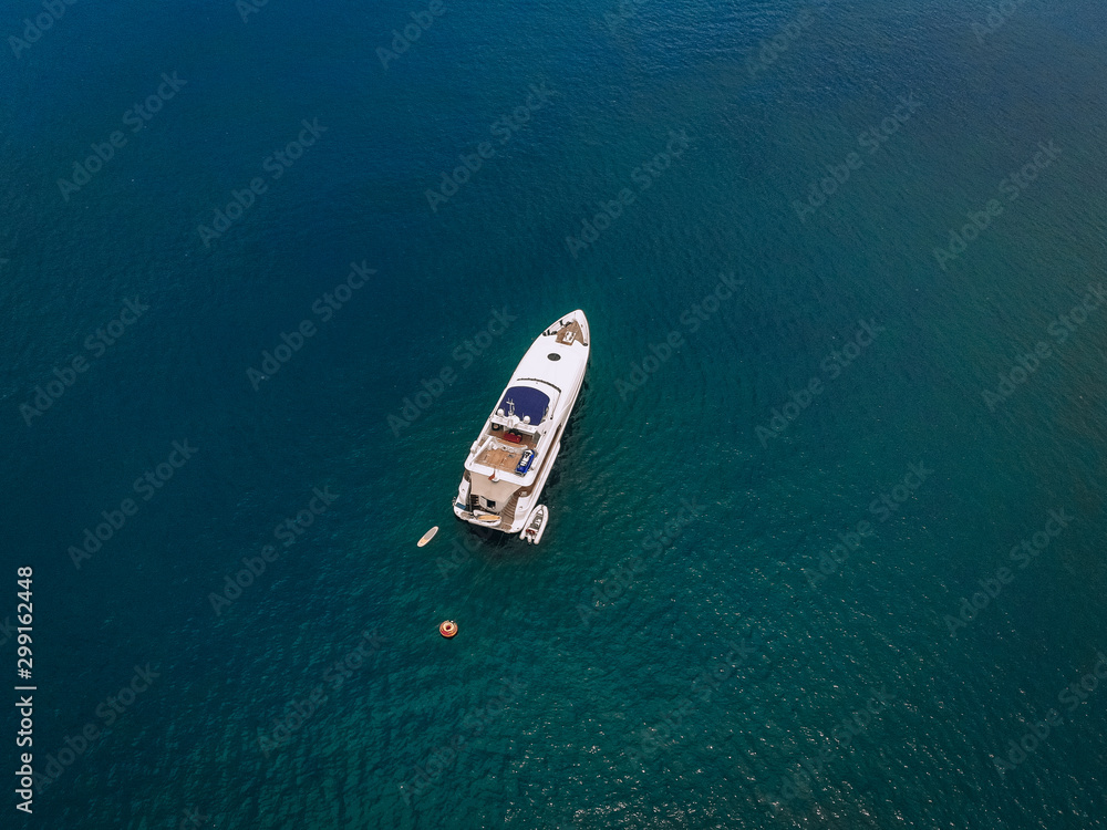 Top view of the luxurious yacht in the vast blue sea; lifestyle concept. Top view of the luxurious yacht in the vast blue sea; lifestyle concept.