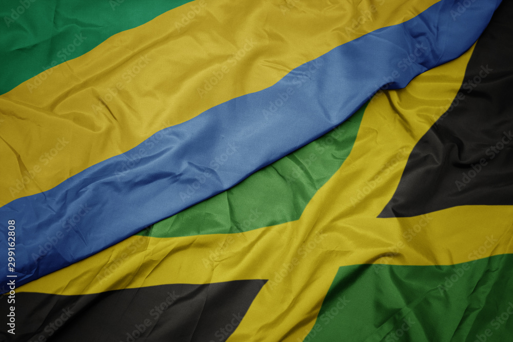 waving colorful flag of jamaica and national flag of gabon.
