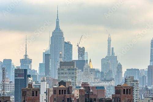 View of New York City from Brooklyn Bridge in the morning with cloudy day.