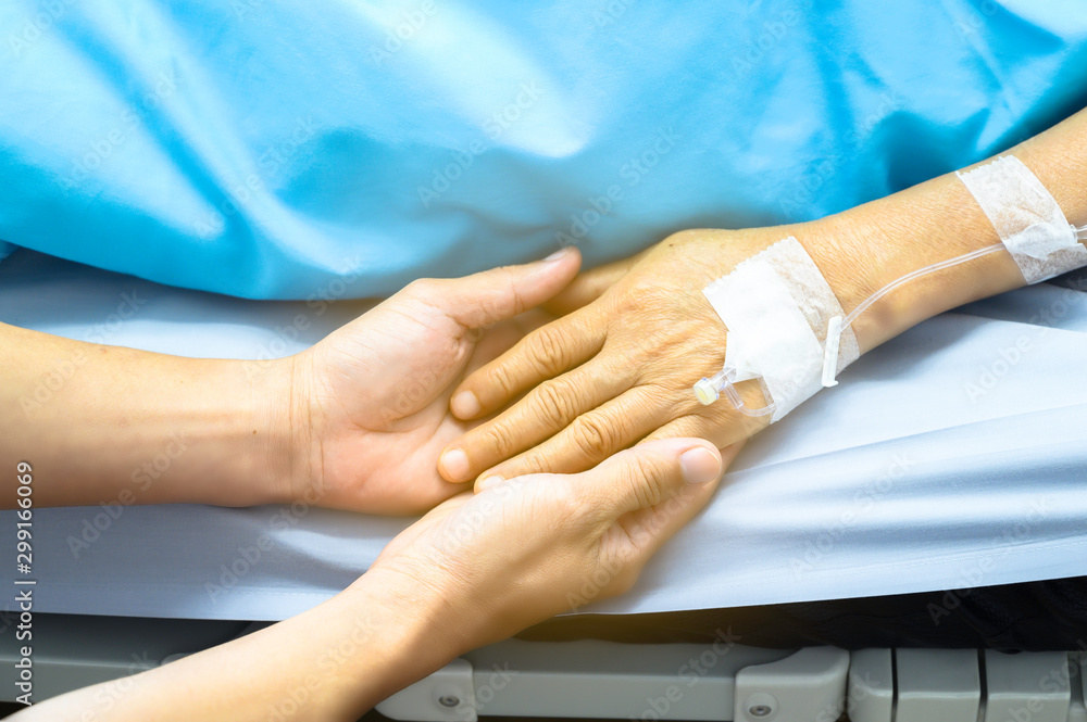 Holding hands Asian senior or elderly old lady woman patient with love, care, encourage and empathy at nursing hospital ward : healthy strong medical concept