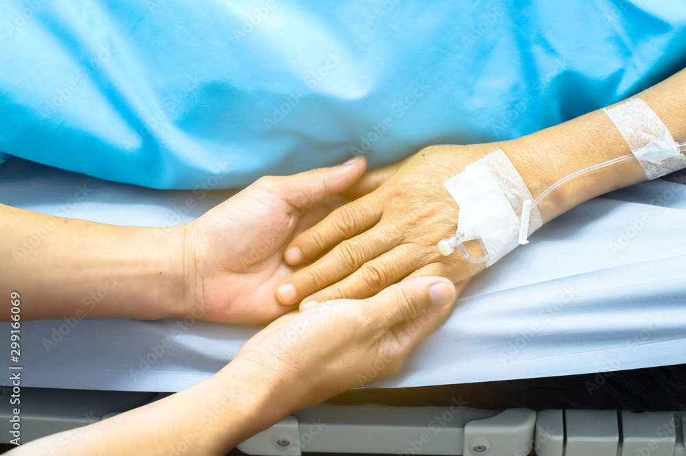 Obraz premium Holding hands Asian senior or elderly old lady woman patient with love, care, encourage and empathy at nursing hospital ward : healthy strong medical concept
