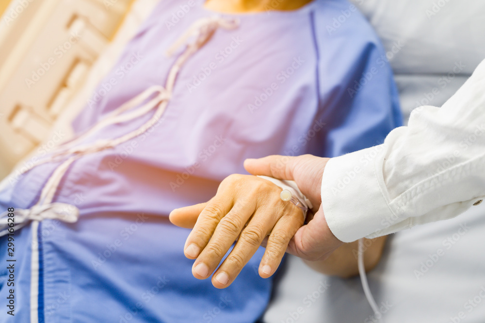 Doctor Holding hands Asian senior or elderly old lady woman patient with love, care, encourage and empathy at nursing hospital Doctor Holding hands Asian senior or elderly old lady woman patient with love, care, encourage and empathy at nursing hospital
