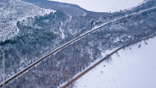 Country road going through the beautiful snow covered landscapes. Aerial view. Drone photography © Igor Syrbu