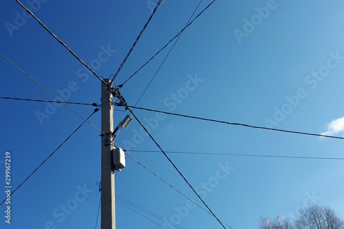 wires and pole against a blue sky