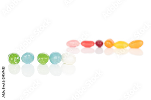Lot of whole jelly bean candy in two lines isolated on white background