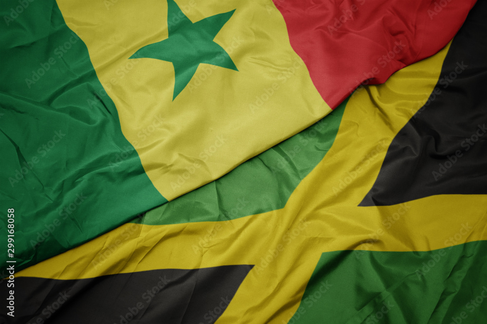 waving colorful flag of jamaica and national flag of senegal.