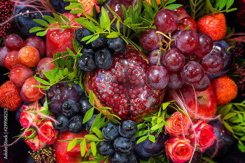 Fototapeta Naklejka Na Ścianę i Meble -  Bright beautiful stew of fruits and flowers close-up
