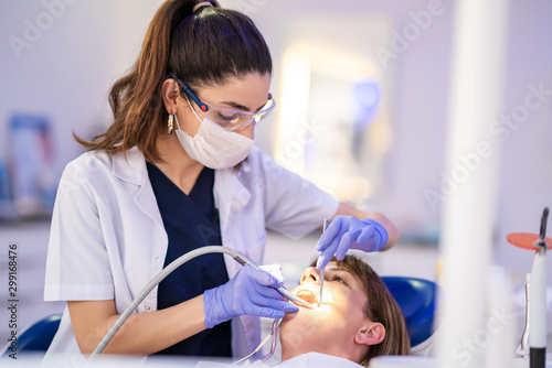 Woman is getting dental treatment in a dentist clinic