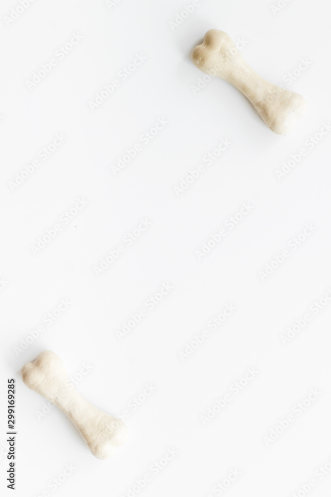 Treats for dogs. Chewing bones on white background top view copy space