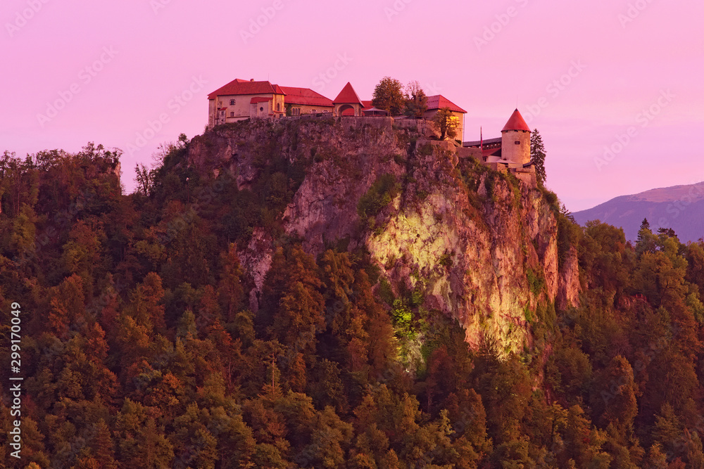 Picturesque landscape photo of Bled Castle on the top of the rock during sunrise. It is a medieval castle built on a precipice above the city of Bled in Slovenia, overlooking Lake Bled