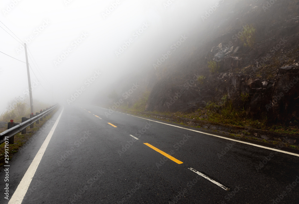 foggy road with yellow markings in the mountainous region of Vietnam