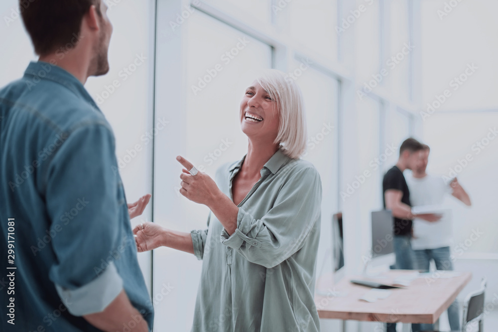 smiling businesswoman explaining something to her colleague smiling businesswoman explaining something to her colleague