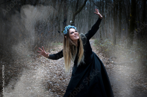 Fotografie, Tablou Pretty blonde in a witch costume for Halloween.