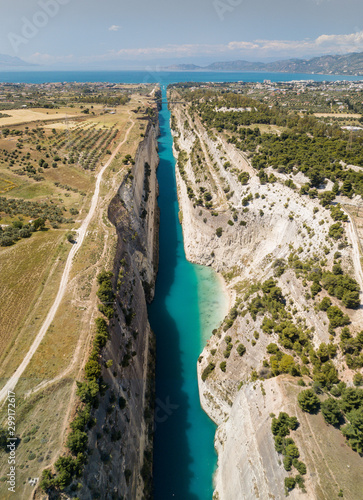 Aerial bird's eye view photo taken by drone of famous Corinth Canal with turquoise water, Peloponnese, Greece. The narrowest channel in the world and engineering marvel.