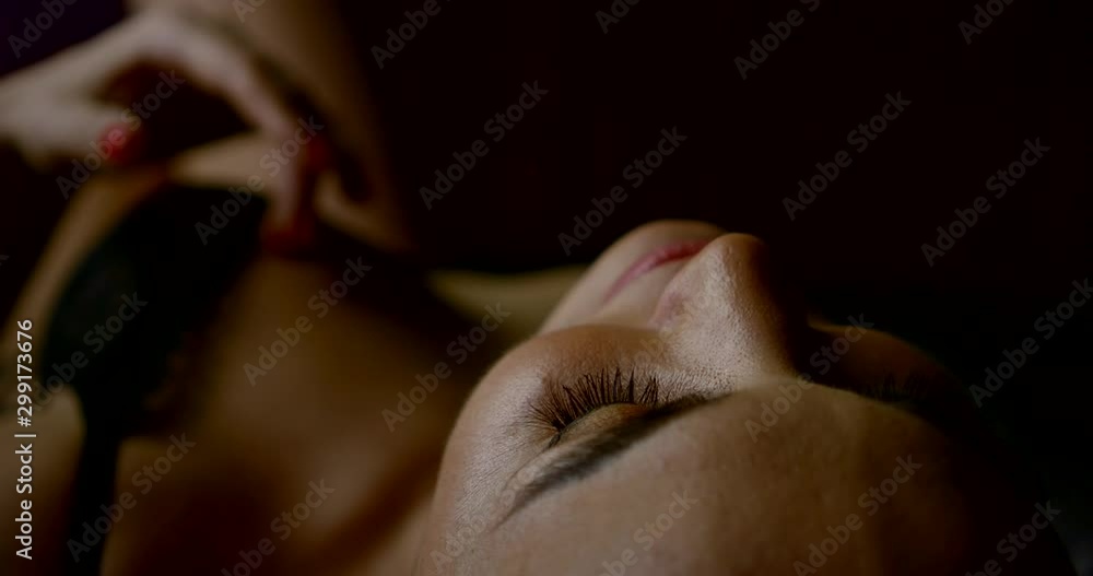 sensual woman dressed in black sexy lingerie is stroking her breast lying in bedroom sensual woman dressed in black sexy lingerie is stroking her breast lying in bedroom