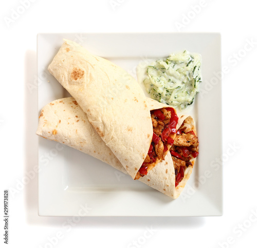 Tortilla with chicken, bell pepper and tzatziki. Isolated with c