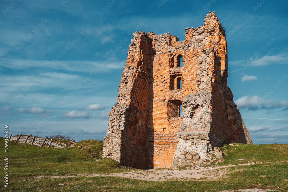 Ruins of Tower Shchitovka and Mindovg Castle on blue sky background in Novogrudok, Belarus.