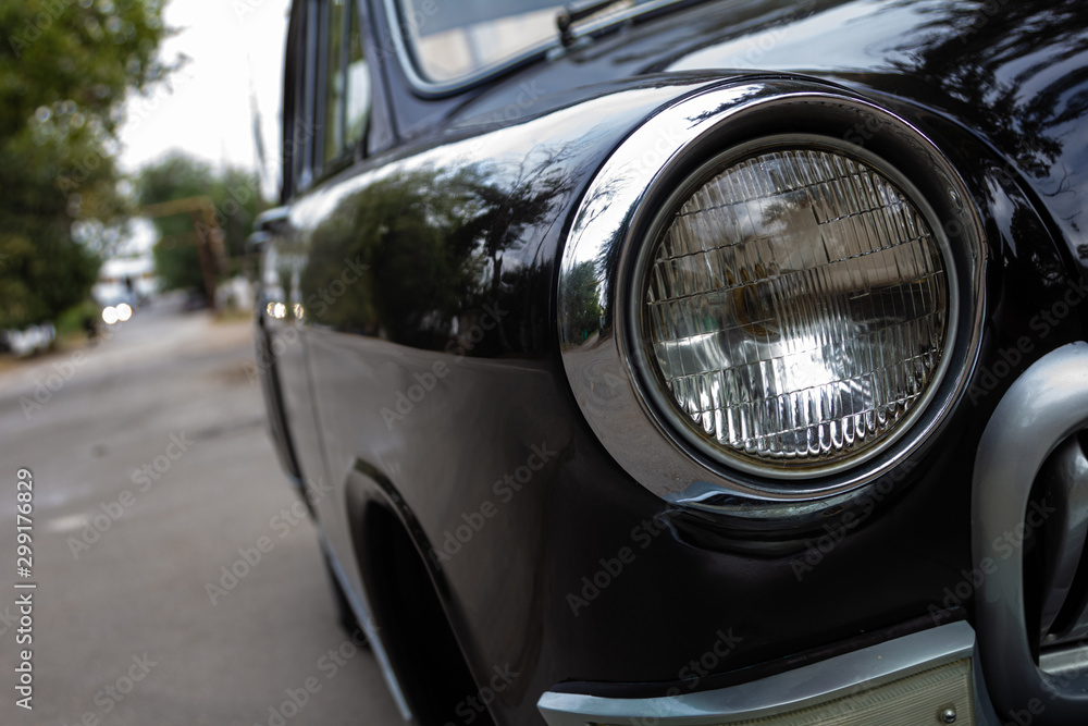 Old luxury car headlight close up