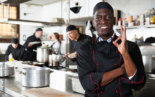 Fotografie African american professional chef male in kitchen of restaurat