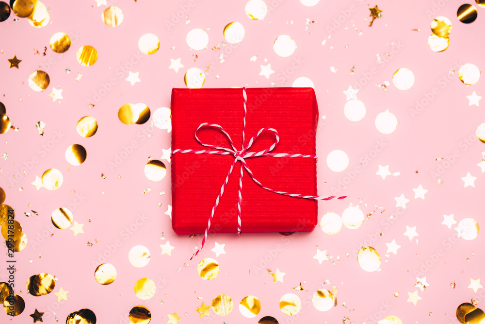 Fototapeta premium Christmas background with purple balls and present gift box and decoration on pink background.