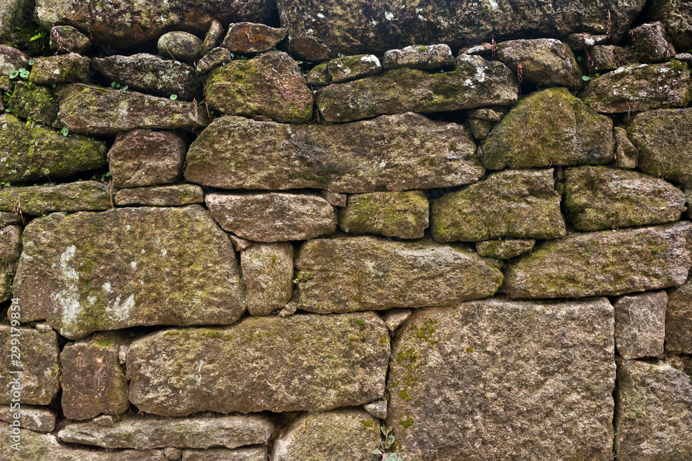 Texture of a stone wall. Old castle stone wall background. Wall made of wild stone. Natural background.