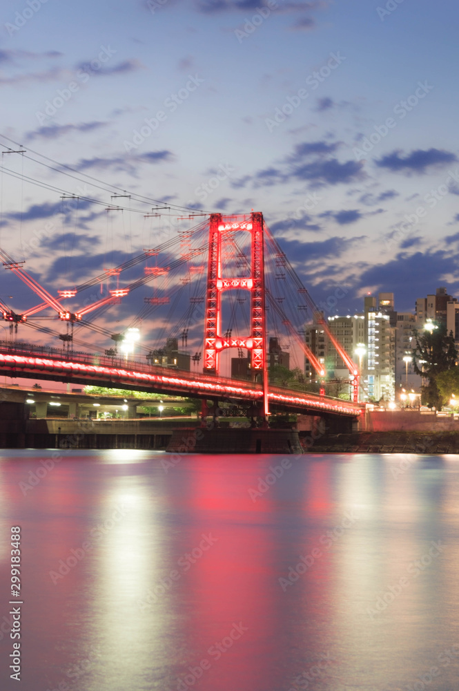 Fototapeta premium Suspension bridge illuminated with led lights. Red. Santa Fe, Argentina.
