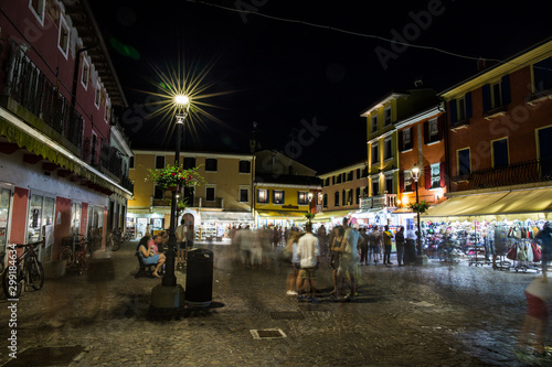 Crowded marketplace in the town center at night. Caorle, Italy.