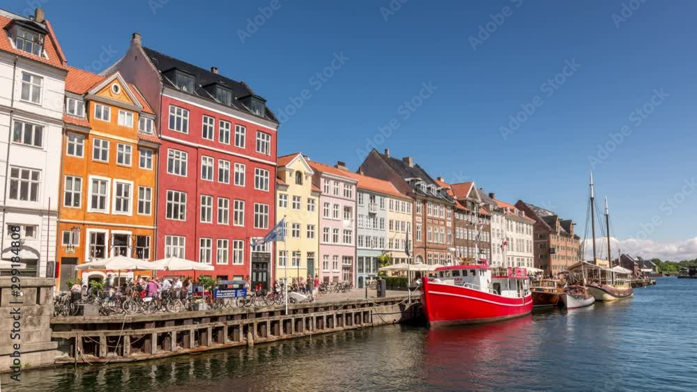 The Nyhavn canal, a 17th-century waterfront and entertainment district in Copenhagen, Denmark. Colorful houses and sailing boats. The Nyhavn canal, a 17th-century waterfront and entertainment district in Copenhagen, Denmark. Colorful houses and sailing boats.