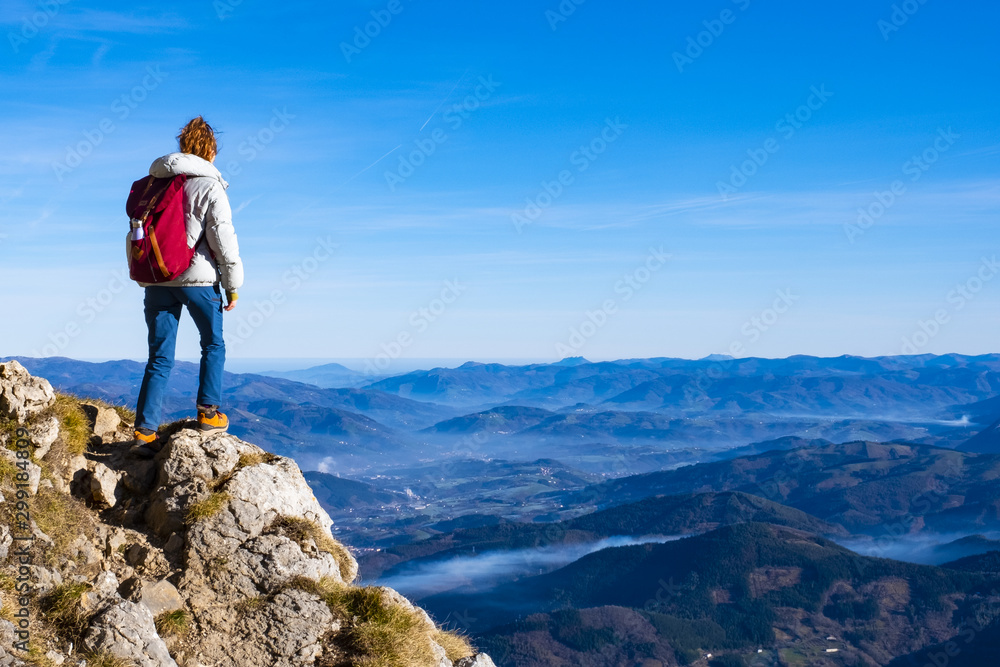 Woman Traveler with Backpack hiking in the Mountains. mountaineering sport lifestyle concept.