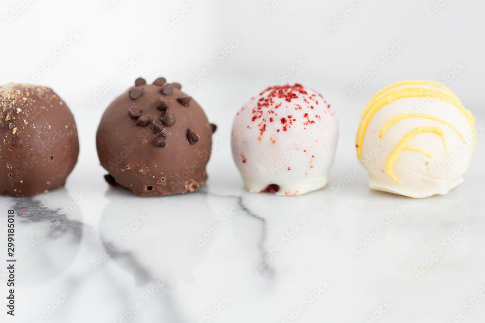 Obraz premium Assorted truffles on white marble background