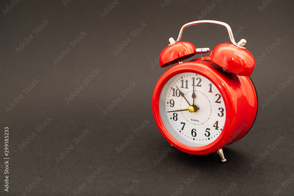red alarm clock on black background red alarm clock on black background