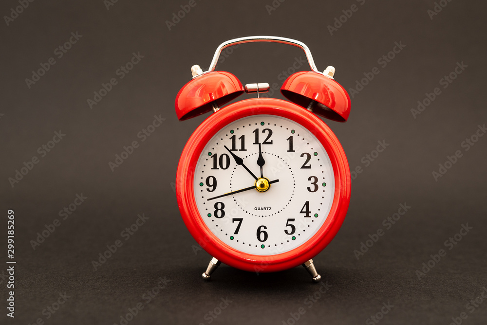 red alarm clock on black background red alarm clock on black background