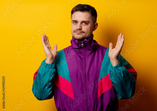Style man in 90s tracksuit on yellow background photo
