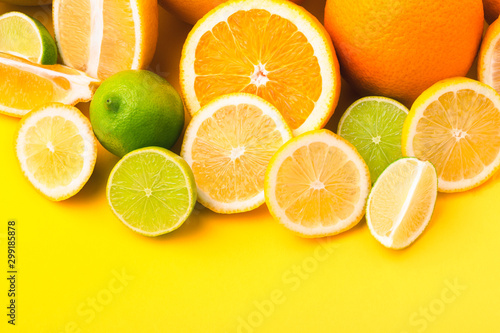 Citrus fruits  orange  lemon  grapefruit  lime  on yellow background. Summer concept. Set of tropical fruits