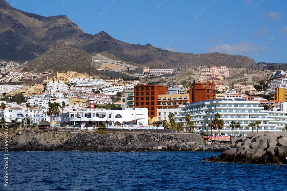 Waterside distant view touristic place Los Cristianos coastline, resort town, situated on south coast of Canary Islands, Spain