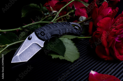 A small pocket knife. Pocket knife and flowers. photo