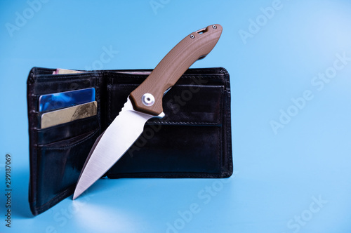 Knife, wallet and money. Knife and credit cards.