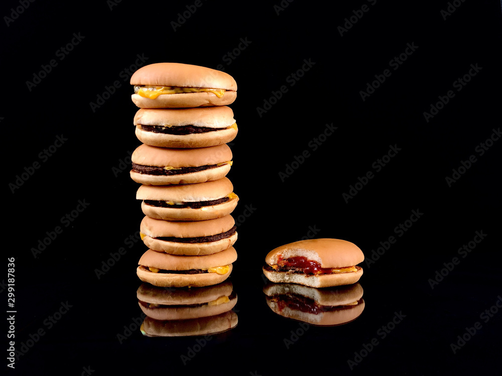 Tasty burgers on a black background. Sandwiches with meat, cheese and vegetables. A large number of hamburgers. Tasty burgers on a black background. Sandwiches with meat, cheese and vegetables. A large number of hamburgers.