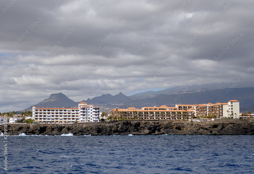 Waterside distant view coastline of Costa del Silencio during stormy weather, moody cloudscape above the town, Tenerife, Atlantic Ocean, Spain Waterside distant view coastline of Costa del Silencio during stormy weather, moody cloudscape above the town, Tenerife, Atlantic Ocean, Spain