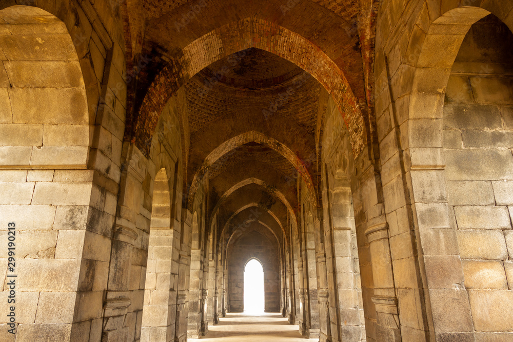 The graceful stone arches inside the archaeological ruins of the Indo-Arabic style Baro Shona Masjid aka The Great Golden Mosque in the ancient capital of Bengal, Gour. 