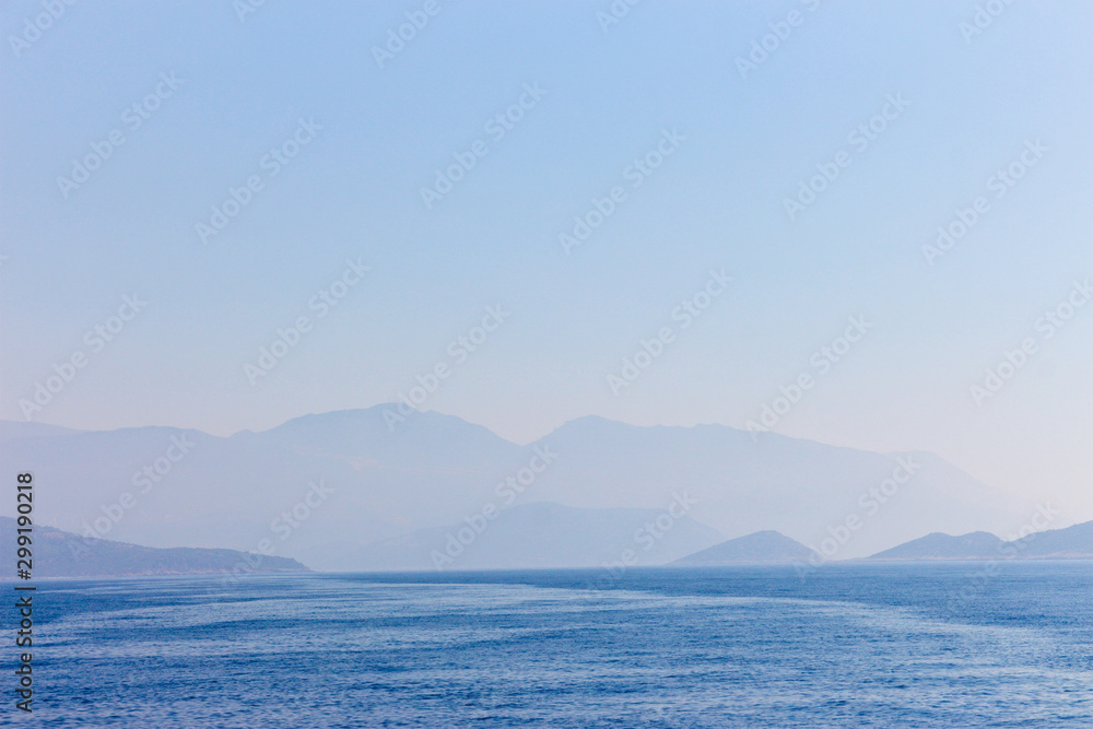 view of the coast and mountains from the sea in the morning fog