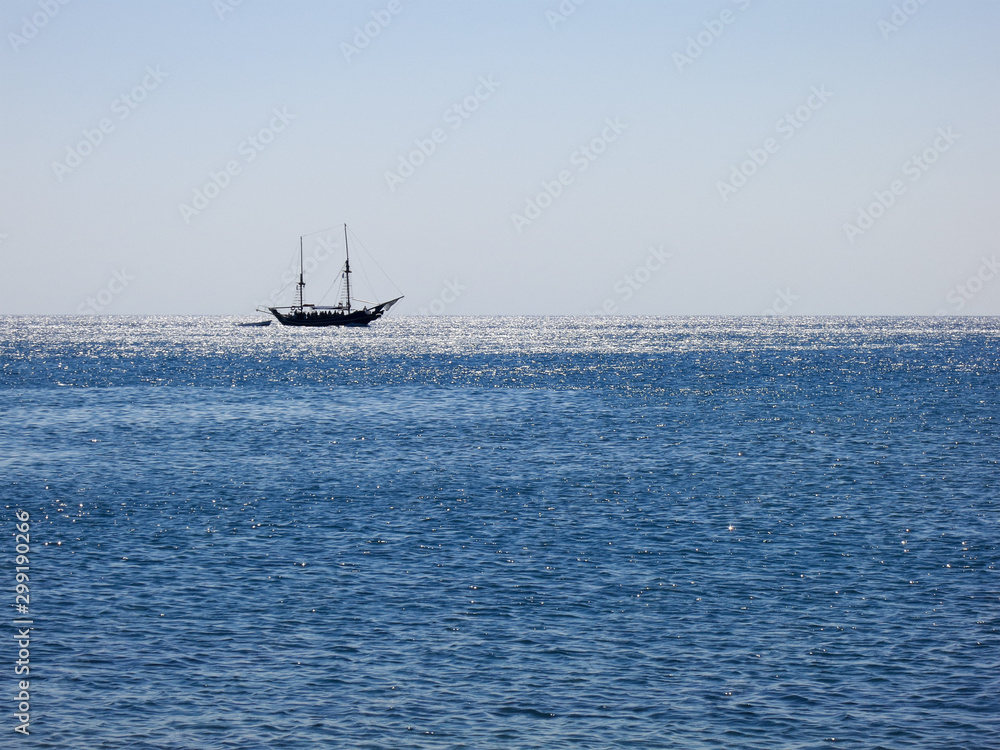 twin mast felucca on the horizon in backlight twin mast felucca on the horizon in backlight