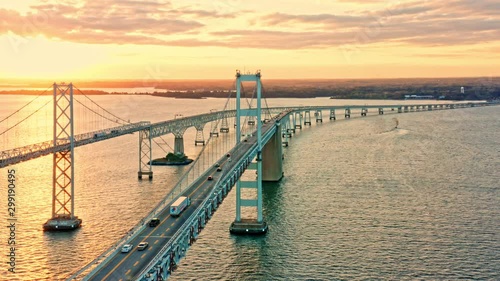 Aerial drone footage of Cheasapeake Bay Bridge, with slow forward camera movement, along the bridge, towards sunset photo