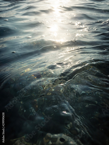 Fototapeta Naklejka Na Ścianę i Meble -  Dark ripple surface of the Mediterranean Sea reflects the sun that flickers beautifully on the water.