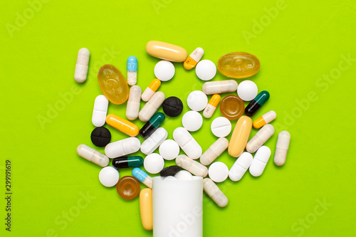  Pills, tablets and capsules from assorted pharmaceuticals in the background. Different Pills for health.
